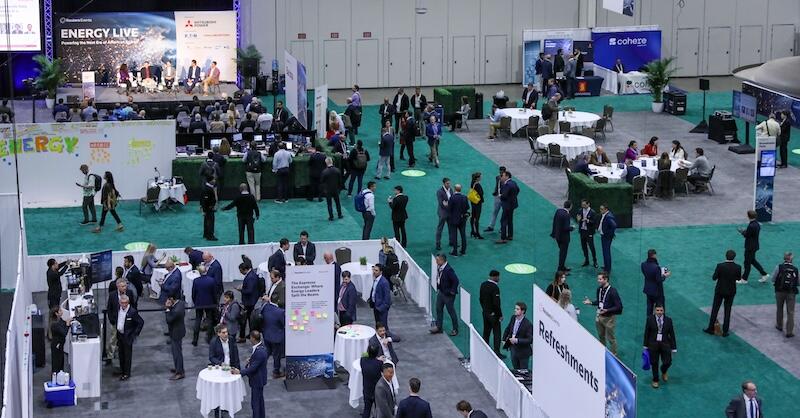 A large expo hall full of people and tables