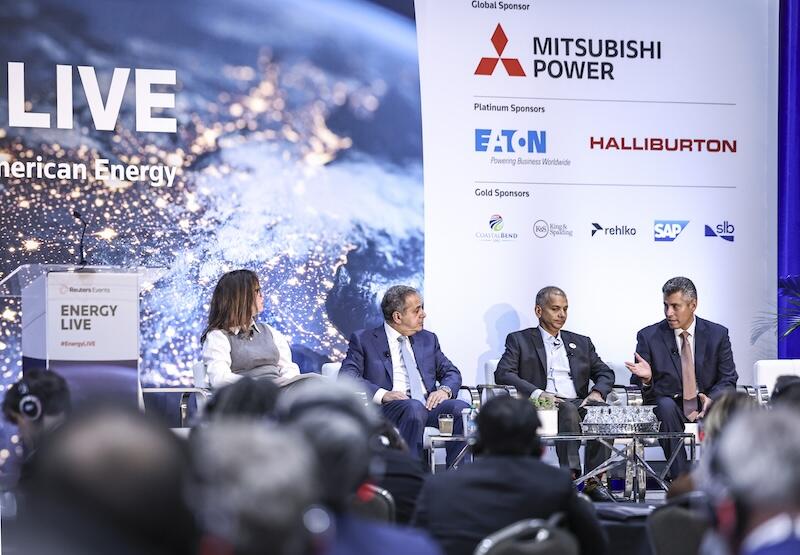 Four people on stage presenting a topic