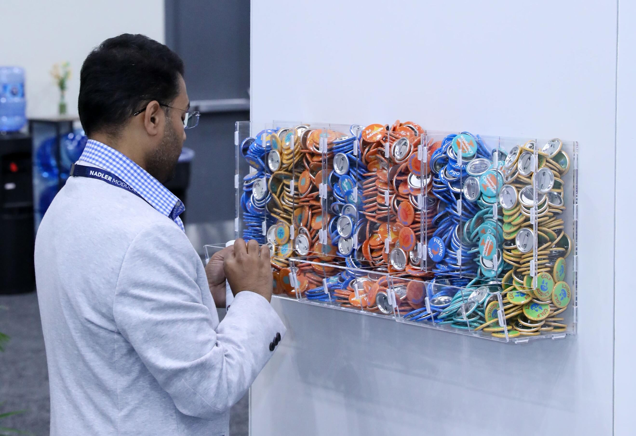 A person picking a badge