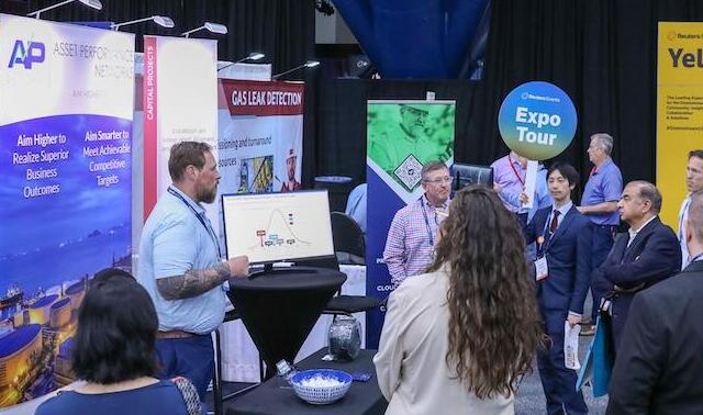 An exhibitor demostraing their product to a group of people 