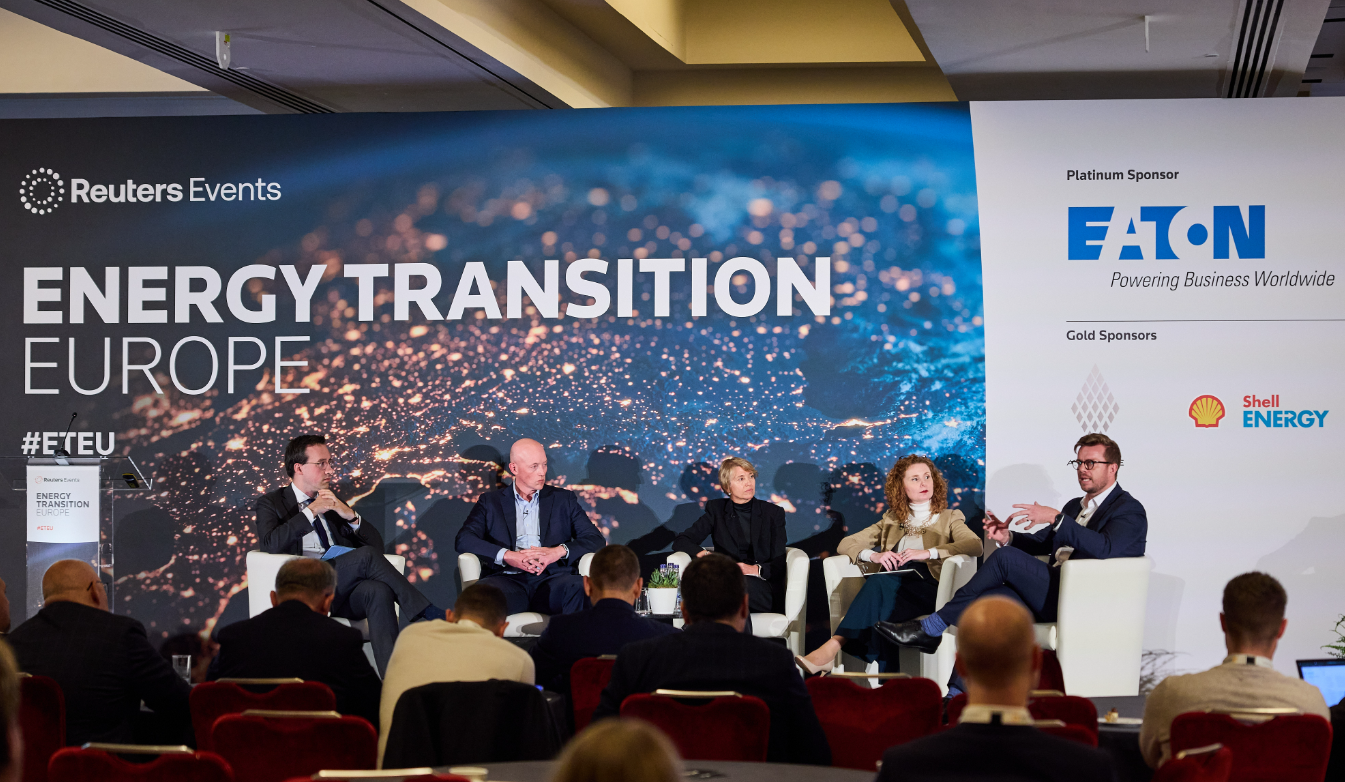 Panel discussion onstage at Reuters Events "Energy Transition Europe," with Eaton and Shell Energy sponsor logos behind the speakers.