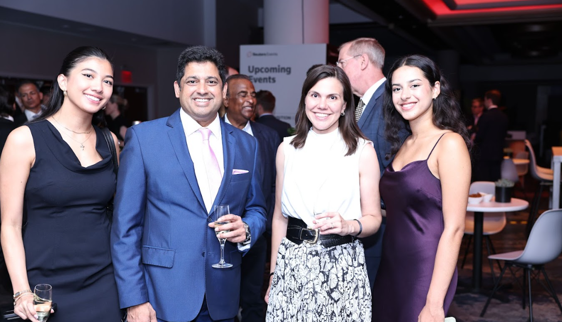 Group of guests standing and smiling at the camera during the awards reception.