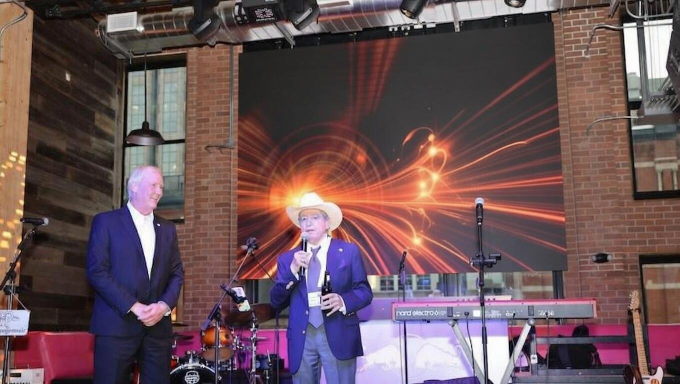 Two speakers on stage open the Day 1 SMR & Advanced Reactor networking party, with event signage and band setup visible.