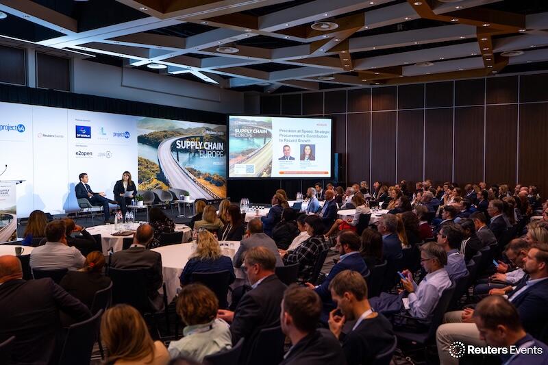 A presentation with a speaker on stage, showing a room full of people at Supply Chain Europe 2025