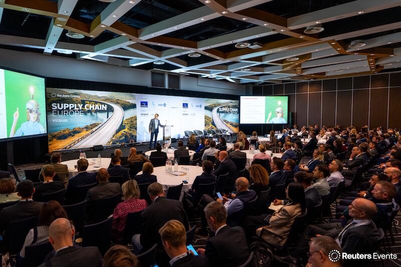 A presentation with a speaker on stage, showing a room full of people at Supply Chain Europe 2025