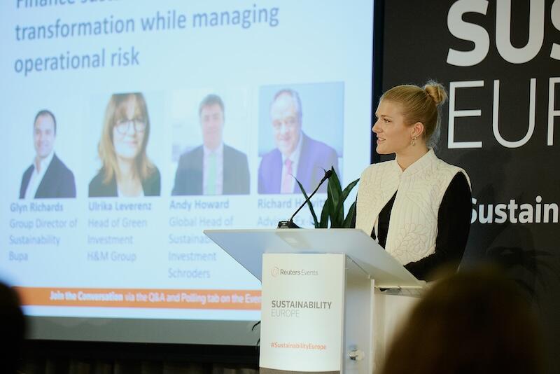 A presenter on stage giving a presentation