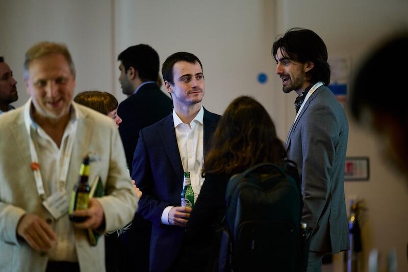 People networking with drinks at the after event.