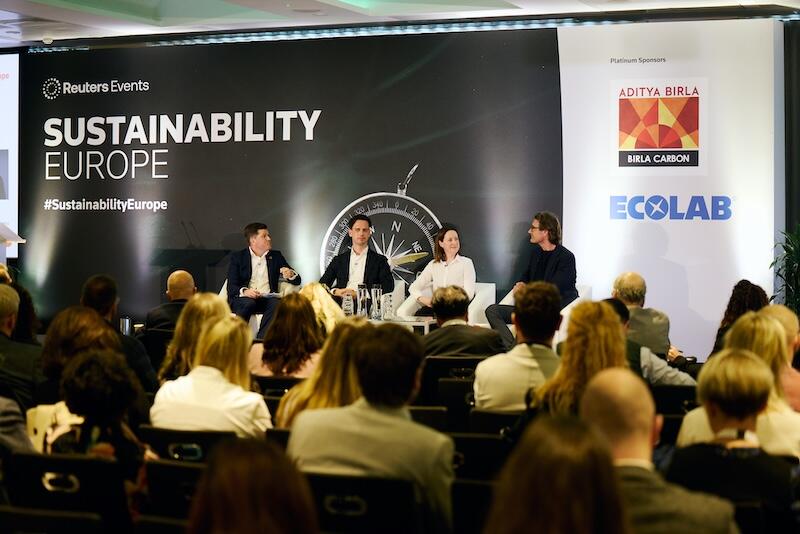 4 presenters on stage giving a panel discussion