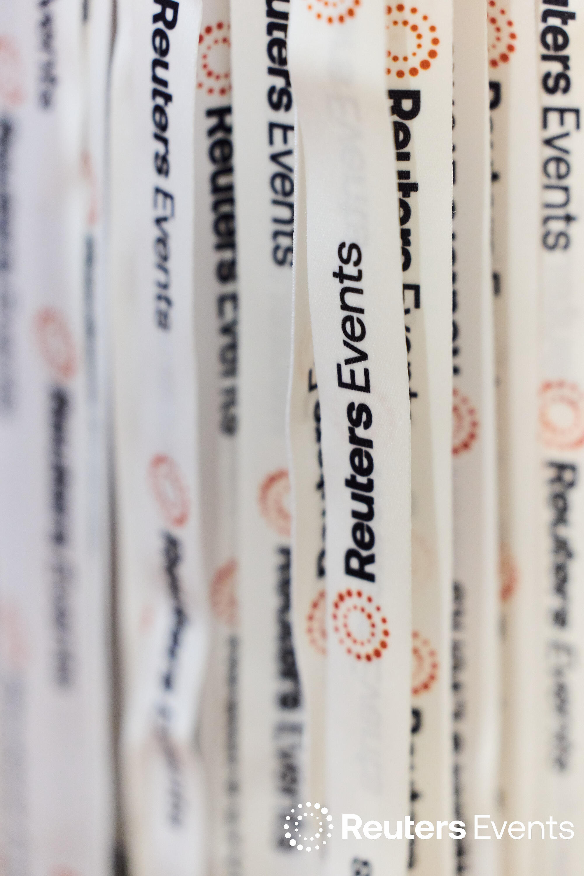 A close-up of multiple white Reuters Events lanyards arranged side by side at the Sustainability Europe conference.