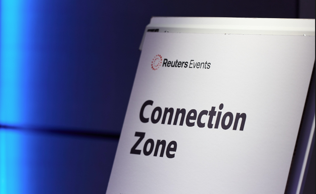 A Reuters Events "Connection Zone" sign displayed against a blue-lit background at the Sustainability Europe conference in Park Plaza Victoria, London.