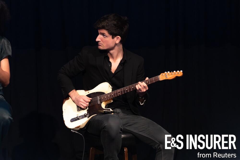 A person on stage holding a guitar