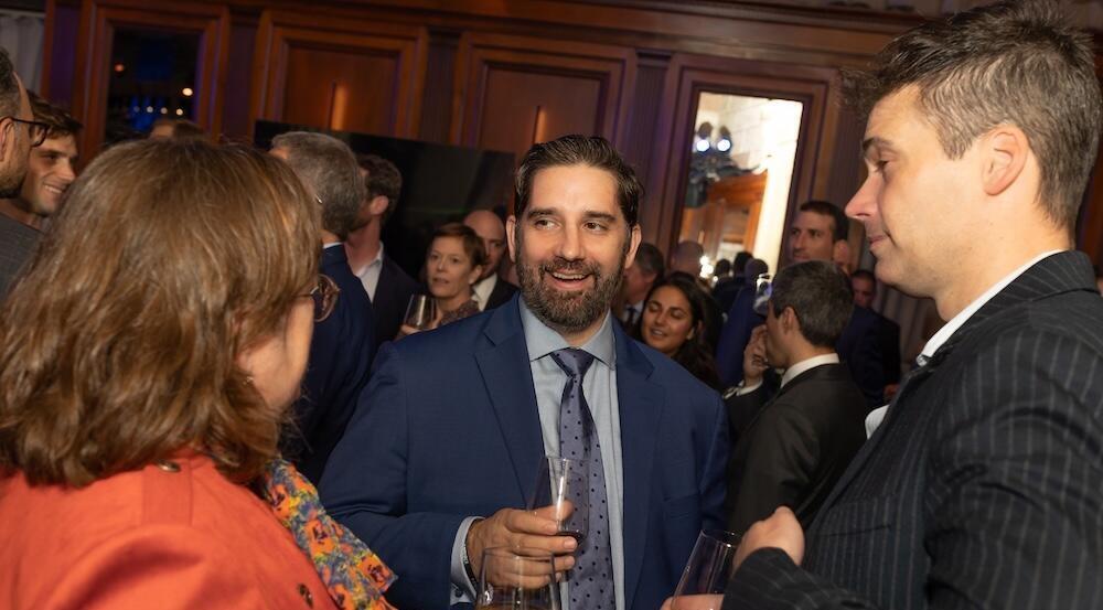 Photo of a social drinks event with people talking