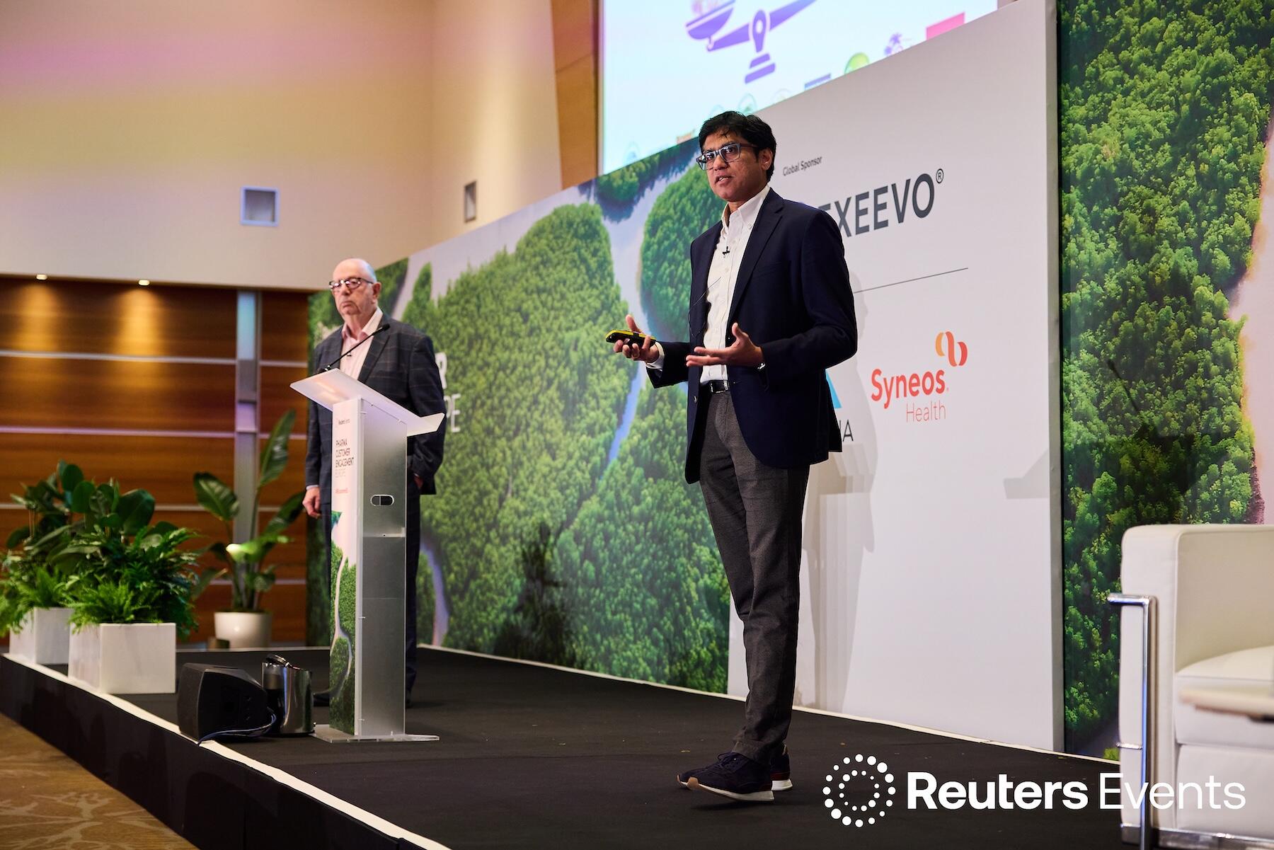 Two people on stage at one of our events.