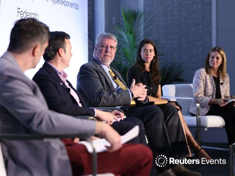 A panel discussion showing 5 people on stage