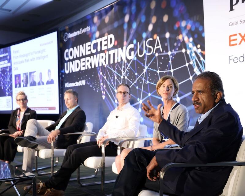 5 speakers on stage. A show where 4 of them are looking as the 5th talks