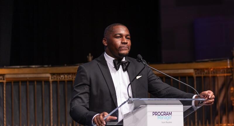 Presenter on stage at a podium