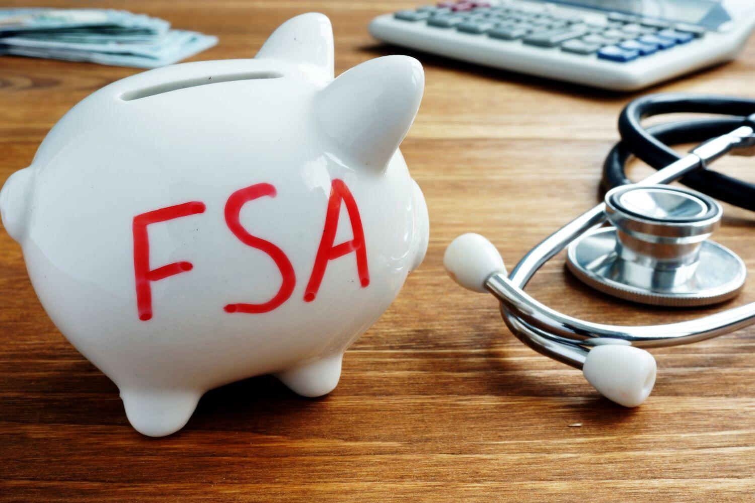 Photo of a white piggy bank with 'FSA' written on it in red marker.